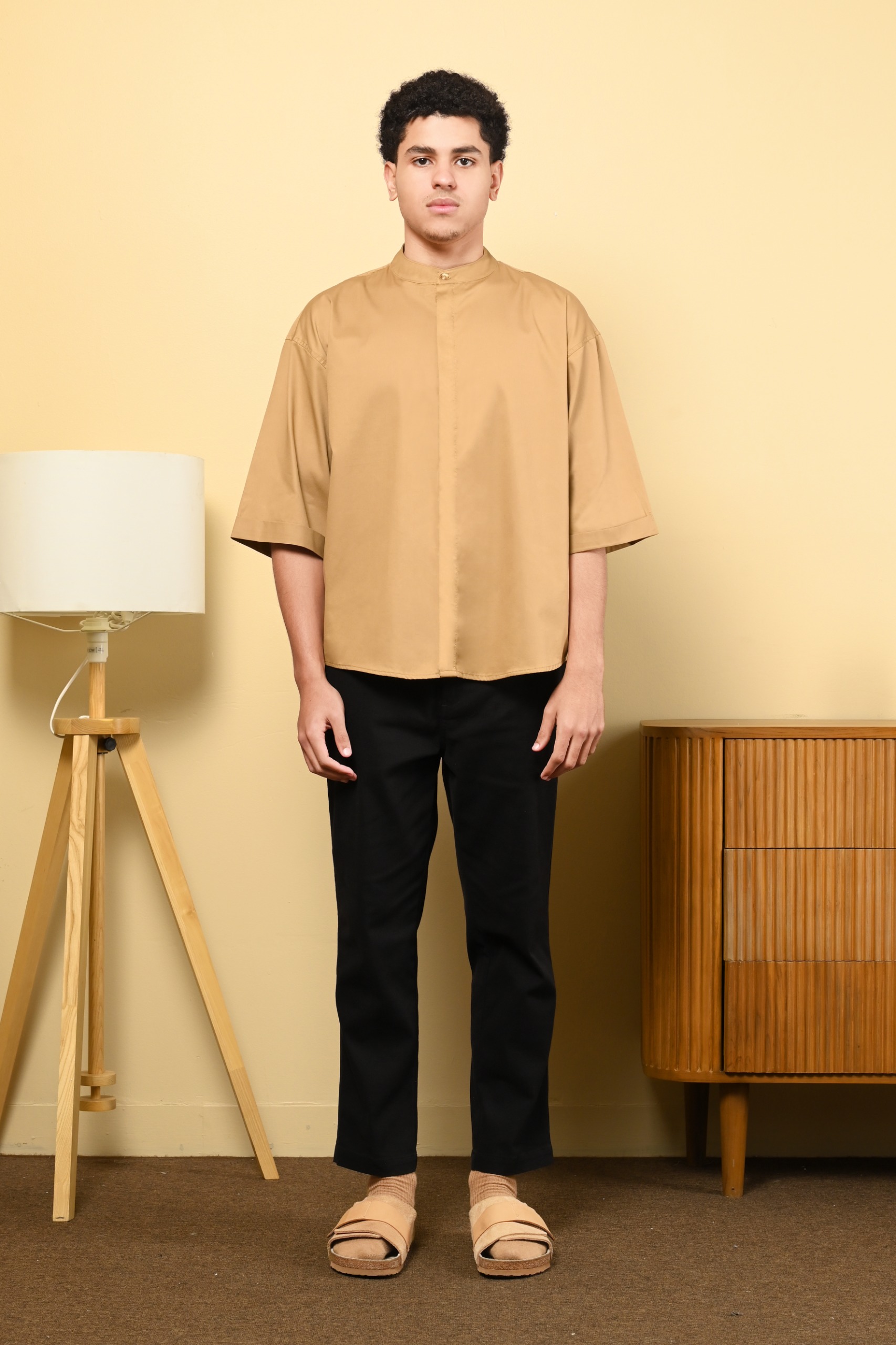 A Woman Wearing a Beige Shirt and Black Pants · Free Stock Photo